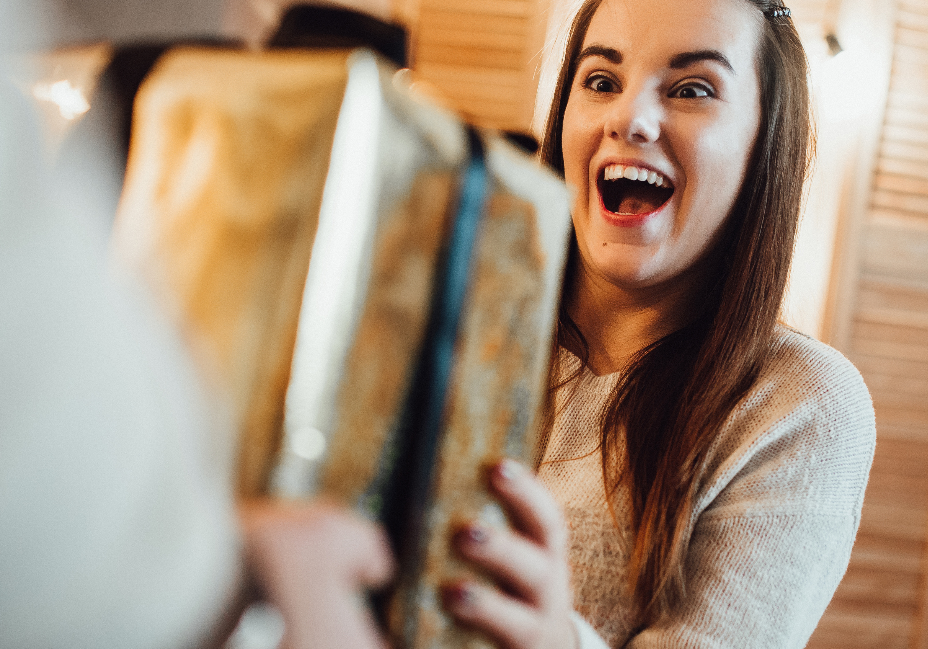 A girl receiving a Christmas present.